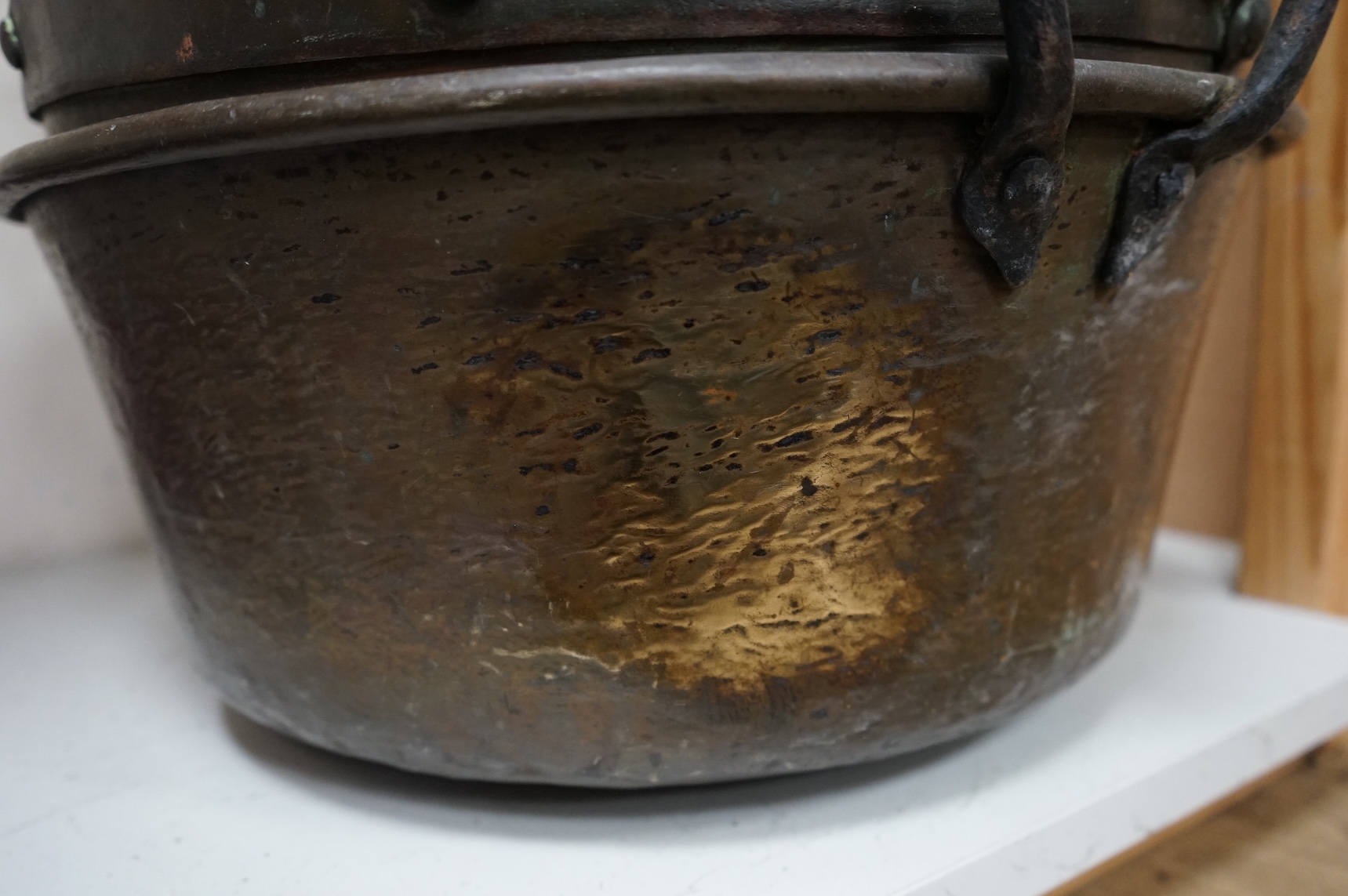 Four copper pans and a copper warming vessel